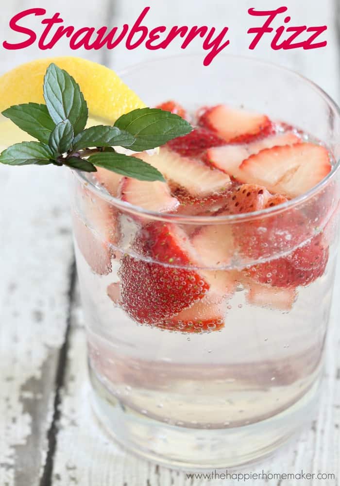 A close up of skinny strawberry fizz cocktail with fresh strawberries