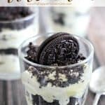 A cup of dirt cake topped with an Oreo