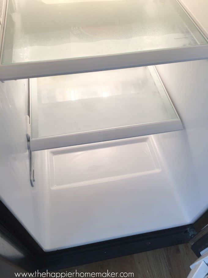 A close up of an open, empty refrigerator