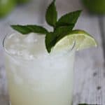 A glass of key Lime Mojito topped with a lime slice