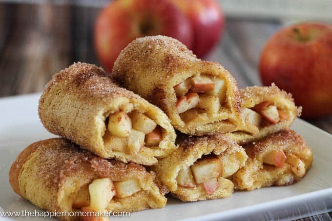 apple pie roll ups stacked on a white dish