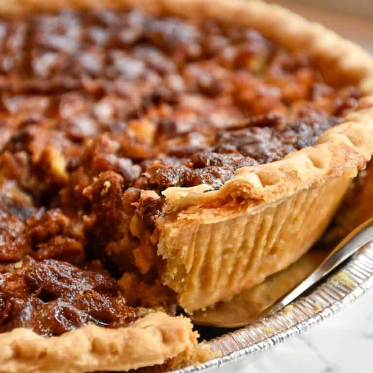 slice of pecan pie being lifted from dish