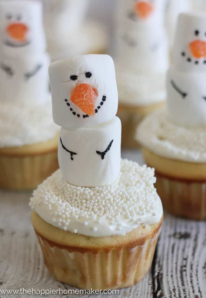 Four snowman cupcakes made from marshmallows and cupcakes 