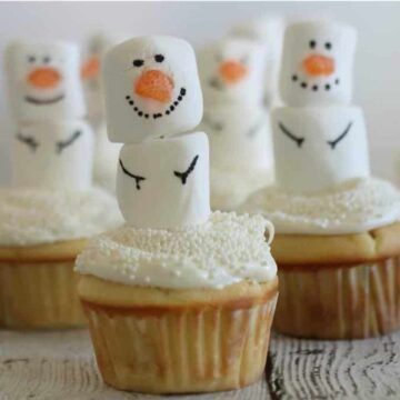 cupcakes with white frosting and marshmallow snowmen