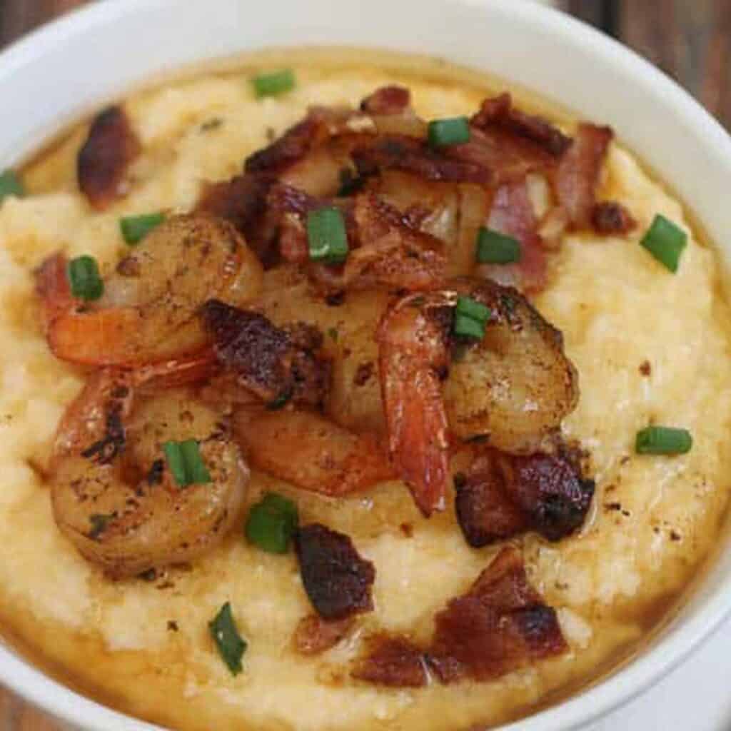 close up of shrimp and grits in white bowl