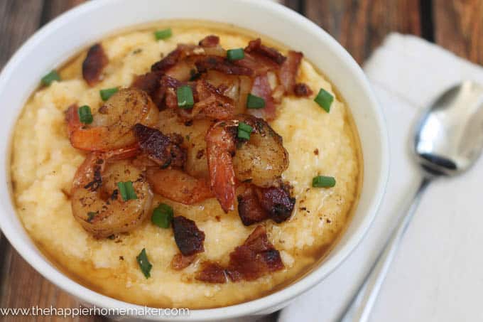 shrimp and grits in white bowl with spoon