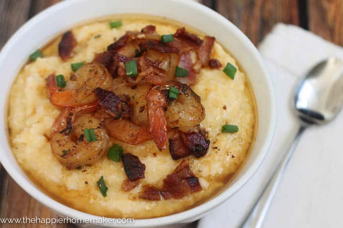 white bowl with shrimp and grits and chopped green onion