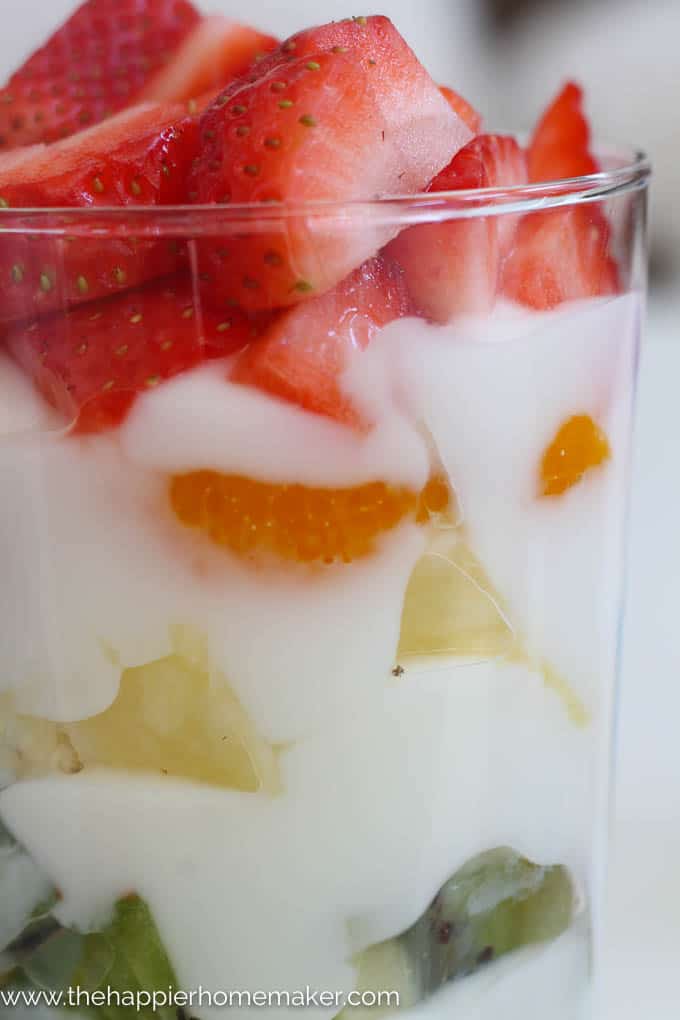 A close up of rainbow yogurt parfaits topped with strawberries