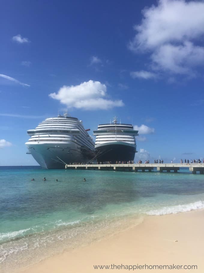 2 cruise ships in the water by pier