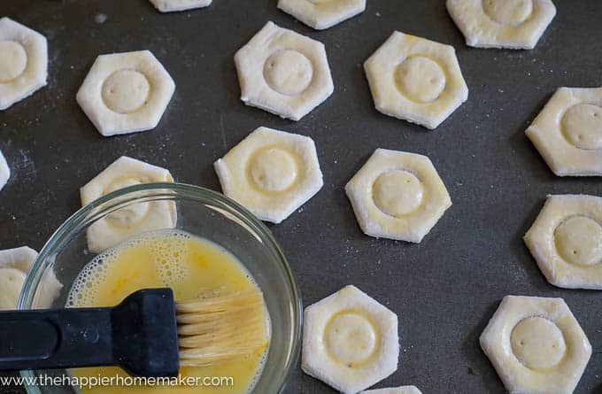 brushing puff pastry cups with egg wash