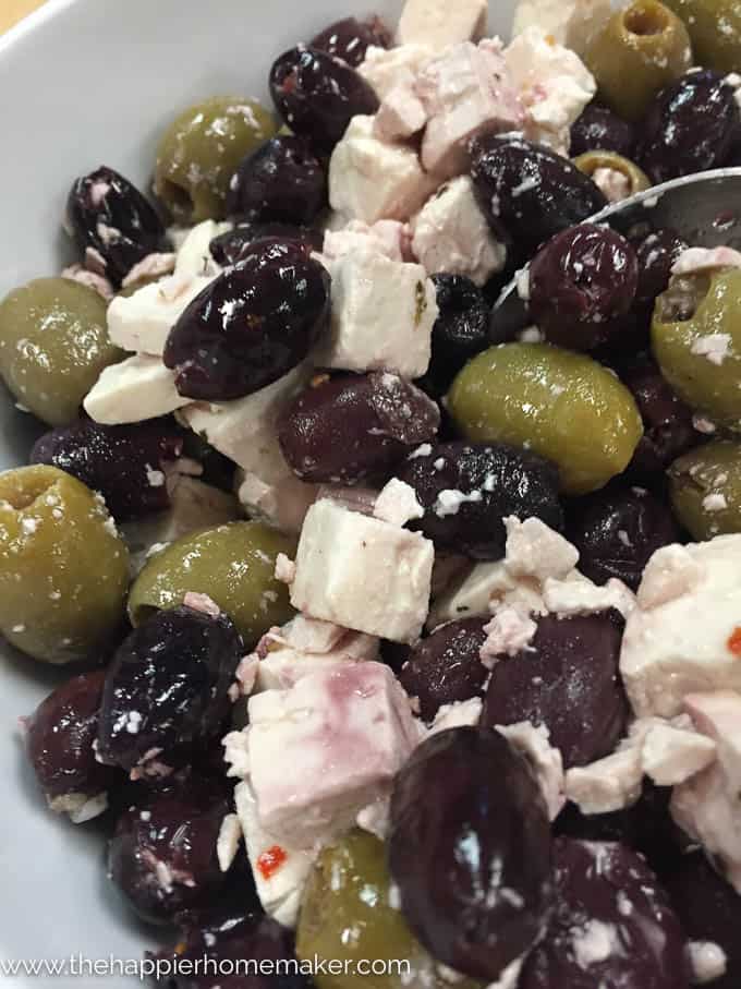 A close up of Greek salad including olives and feta