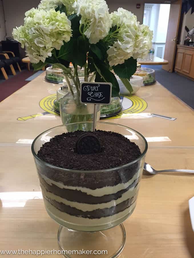 A bowl of dirtcake in front of hydrangea flowers