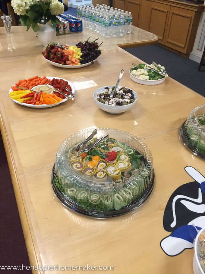 A conference table set up for snacks for a promotion party