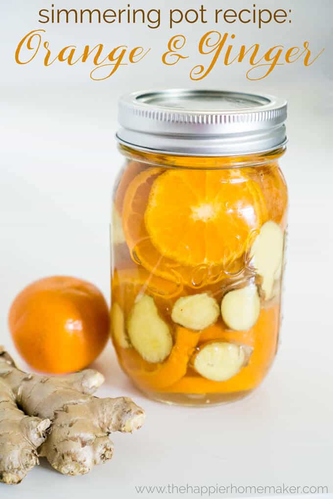 A mason jar of orange and ginger simmer pot with an orange next to it