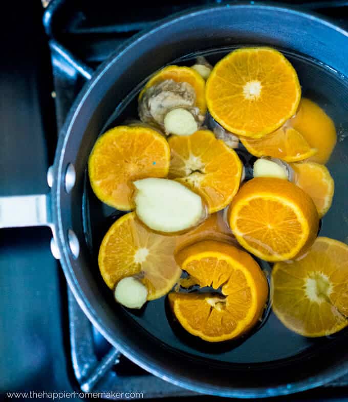 a skillet full sliced oranges prior to simmering for potpourri 