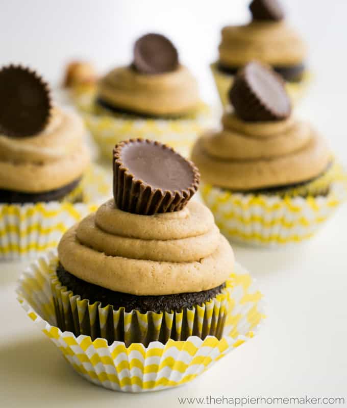 A close up of Reese\'s peanut better cup cakes topped with miniature Reese\'s cups