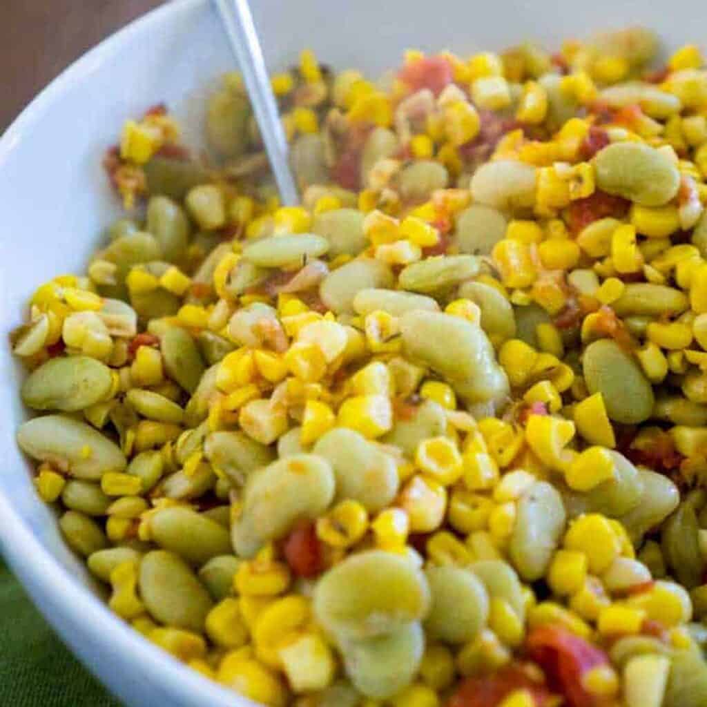 close up of succotash in white bowl