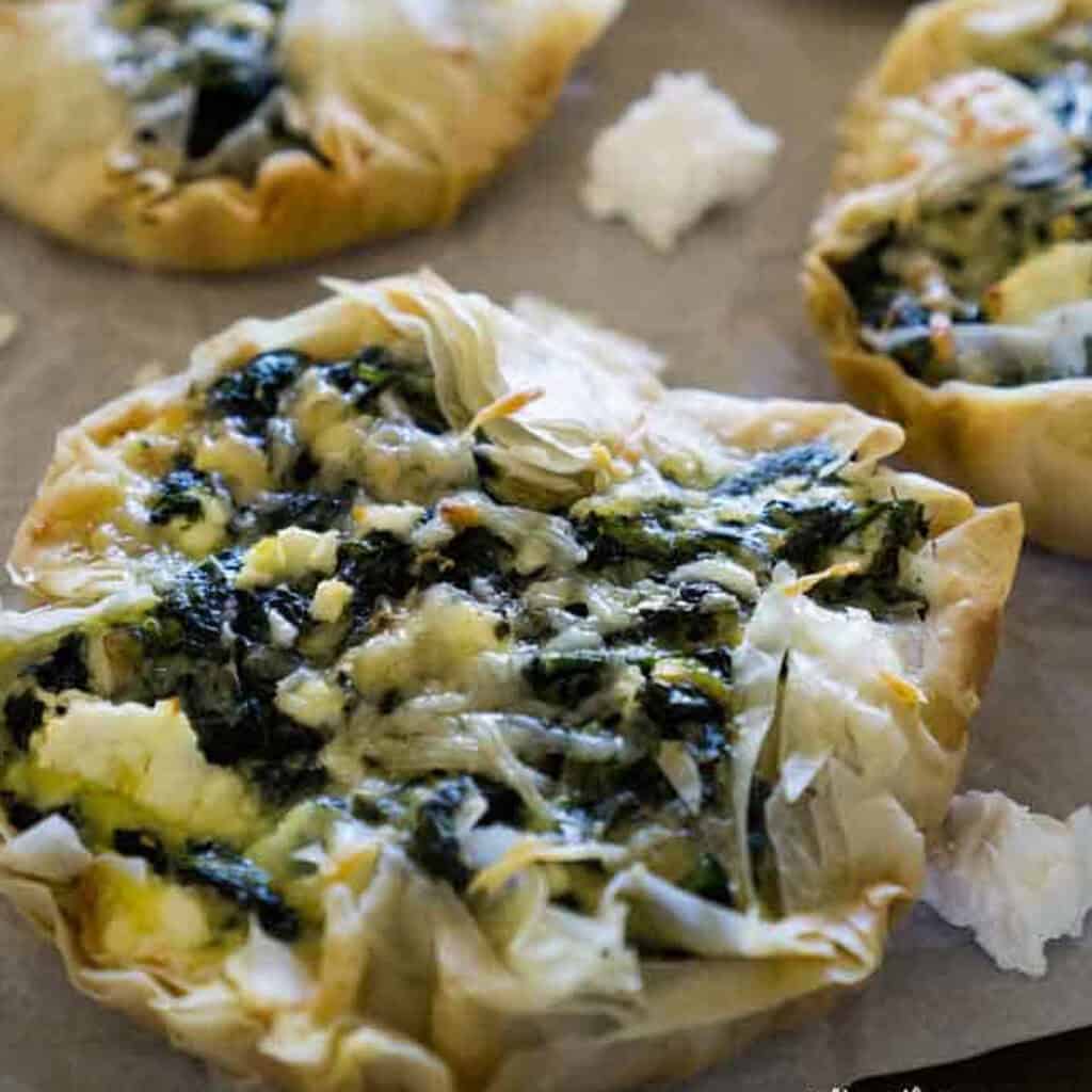 spinach tarts on baking sheet