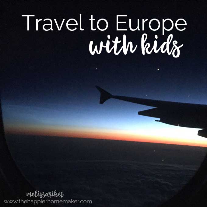 A plane flying as the sun is setting with the words "travel to Europe with kids" 