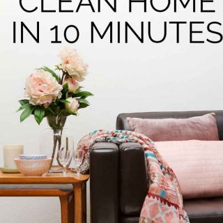 The words "how to fake a clean home in 10 minutes" over a sofa with pillows and a throw blanket next to a side table with flowers and glasses