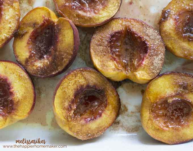 Halved peaches after baking topped with brown sugar and cinnamon
