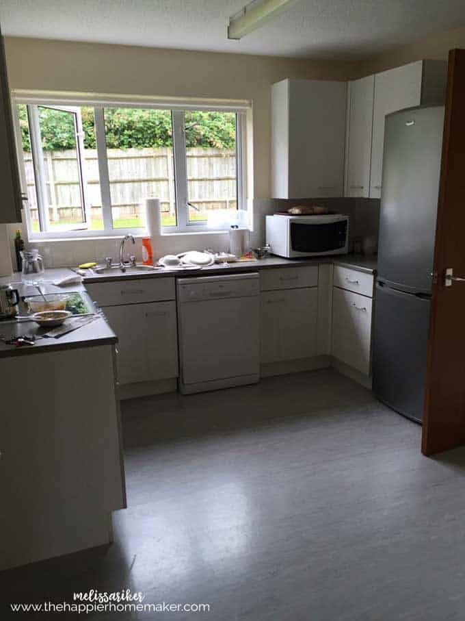 A plain white kitchen that is dark