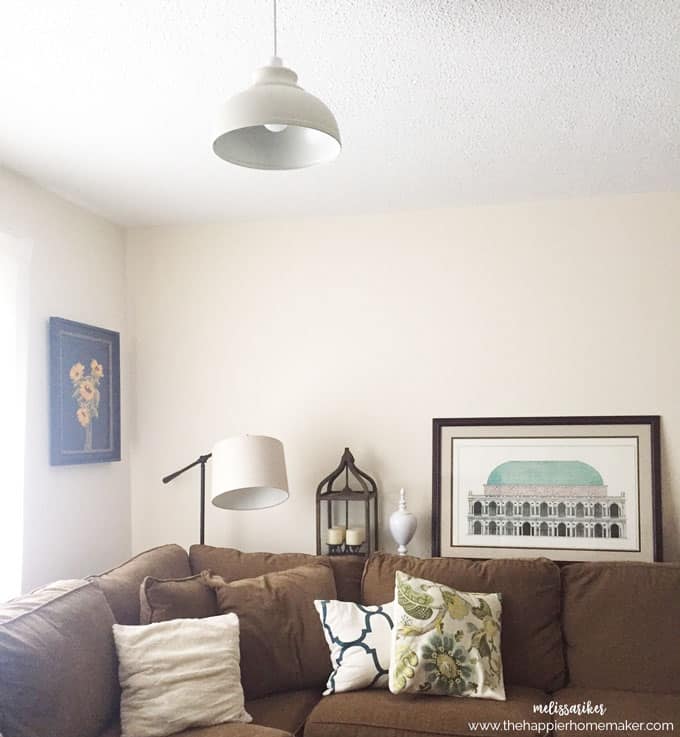 An after picture of a living room with furniture and paintings