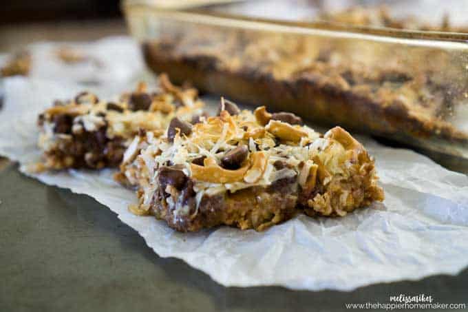 A close up of two pretzel caramel bars with chocolate chips and coconut 