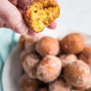 pumpkin doughnut holes on white plate