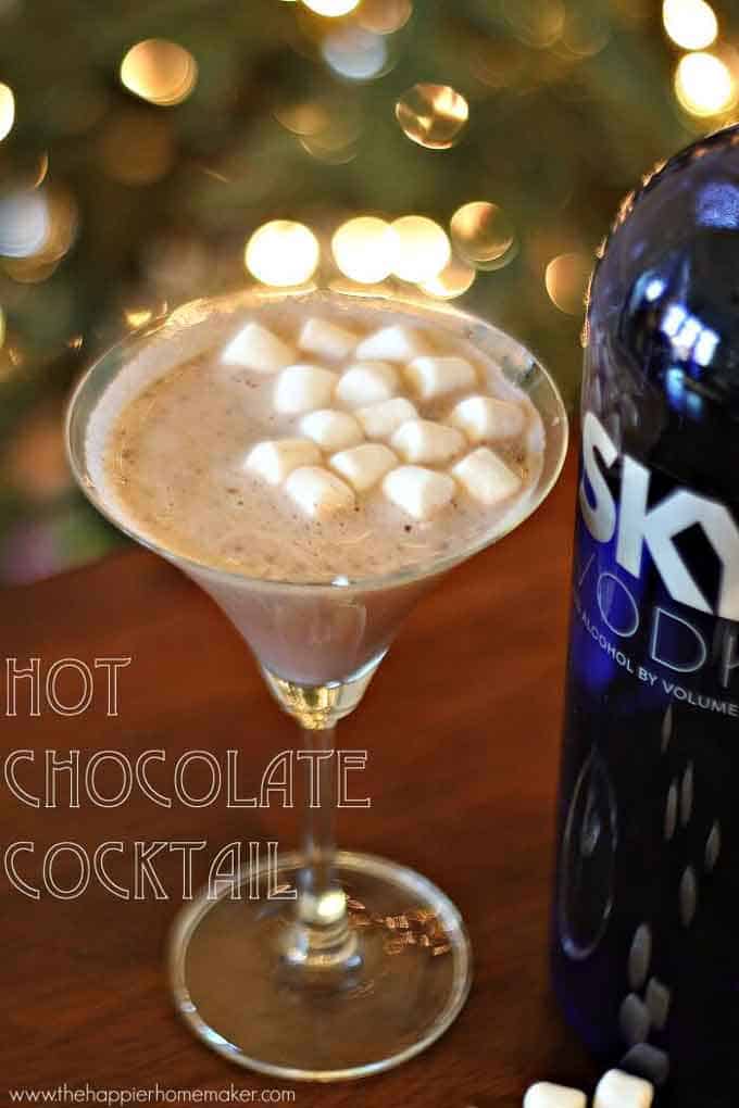 A hot chocolate cocktail next to a bottle of Sky vodka