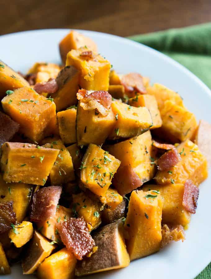 Slow cooker herbed sweet potatoes with crumbled bacon! I love crock pot recipes that make weeknight dinners easy!