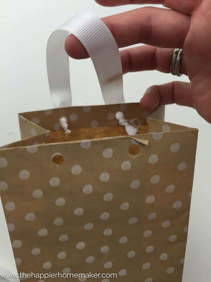 It's easy to make your own DIY Gift Bags in under 5 minutes using wrapping paper, tape and ribbon! Perfect for Christmas or wrapping oddly shaped presents!