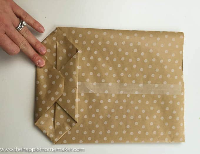 Brown and white wrapping paper folded to be used as a DIY gift bag