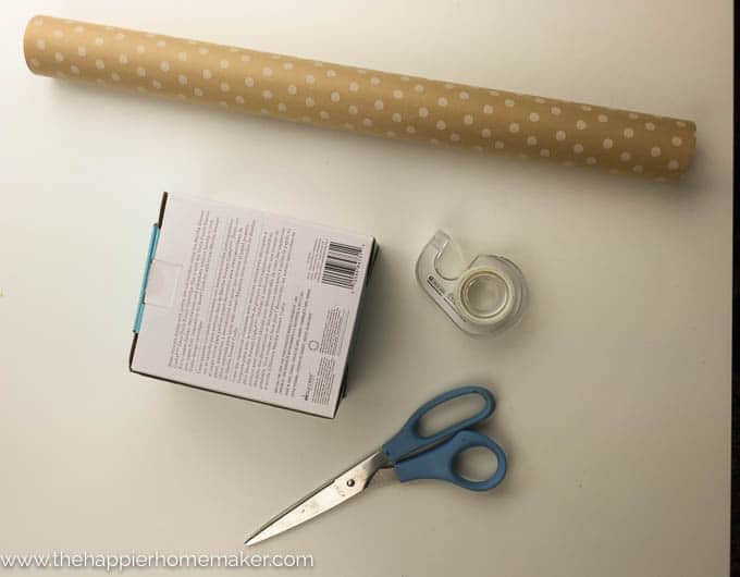 wrapping paper, scotch tape, scissors and a box 