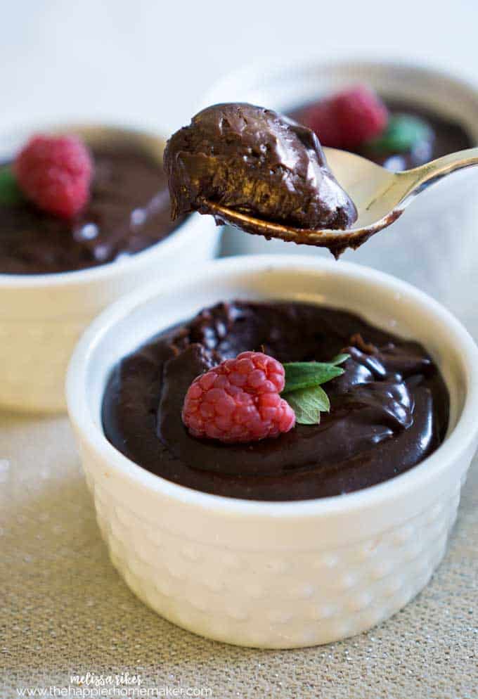 spoon with chocolate mousse over bowl