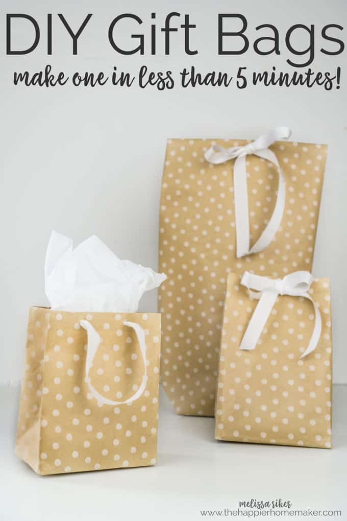 Three different sized gift bags with white ribbons 