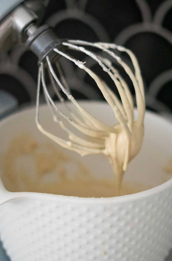 mixer whisk with batter dripping off