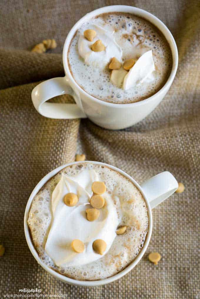 Two white coffee cups of peanut butter hot chocolate