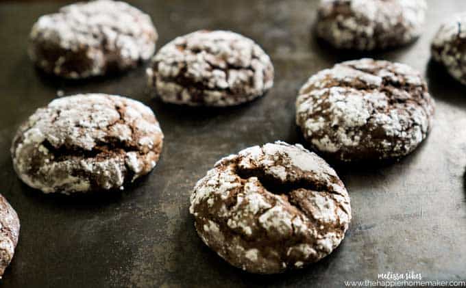 close up of chocolate crinkle cookie on baking sheet