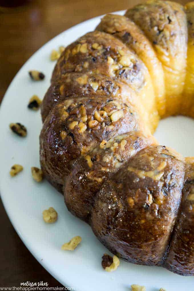 A close up of a butter rum cake with walnuts