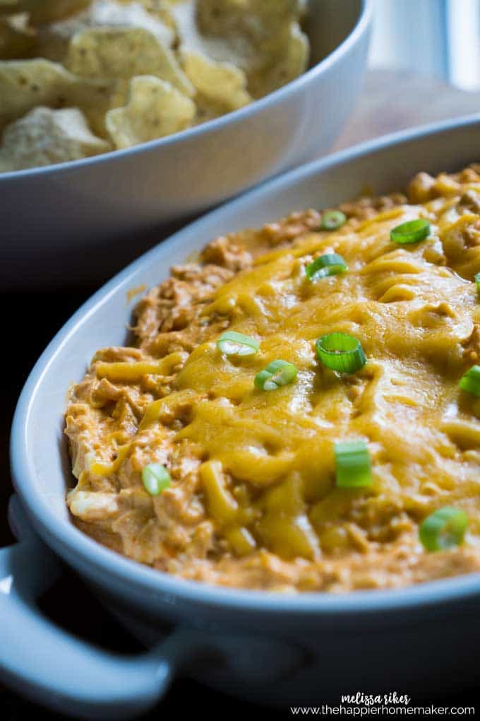 buffalo chicken dip with melted cheese and green onions