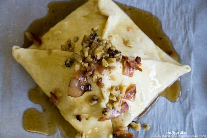 A maple bacon baked brie topped with walnuts