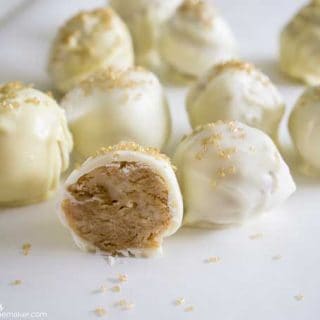 An assortment of white Nilla wafer truffles with one in the foreground cut in half showing the Nilla wafer