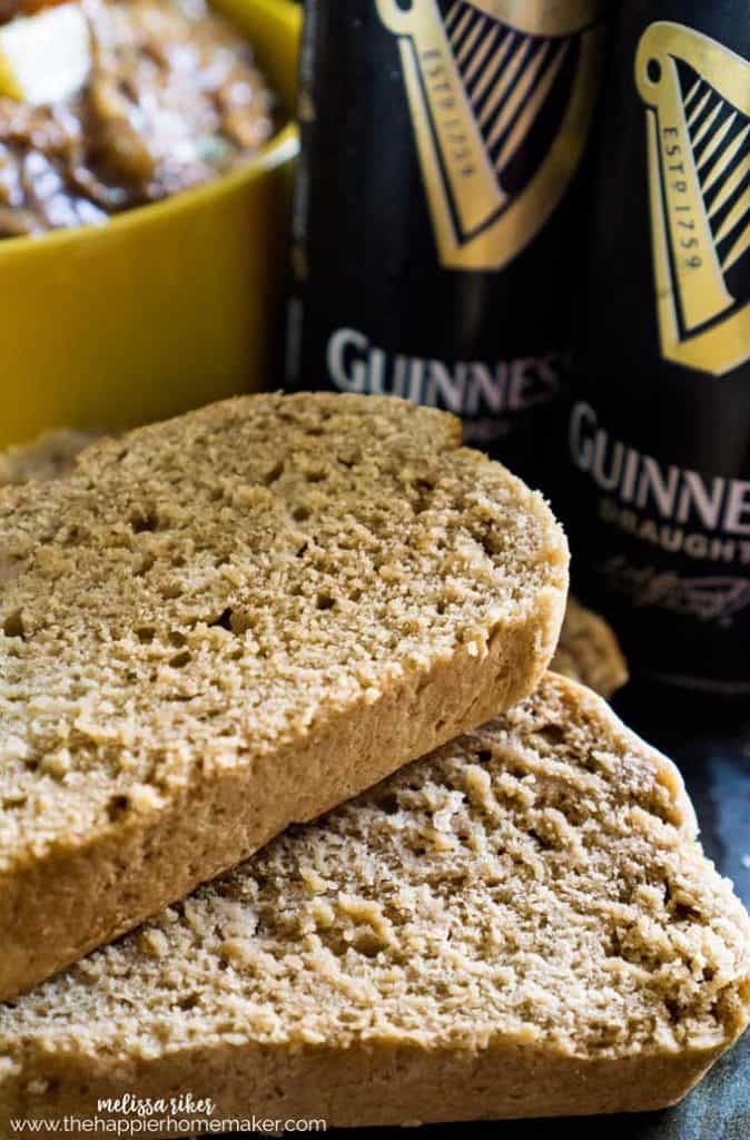 A close up of Guinness beer bread with two cans of Guinness in the background
