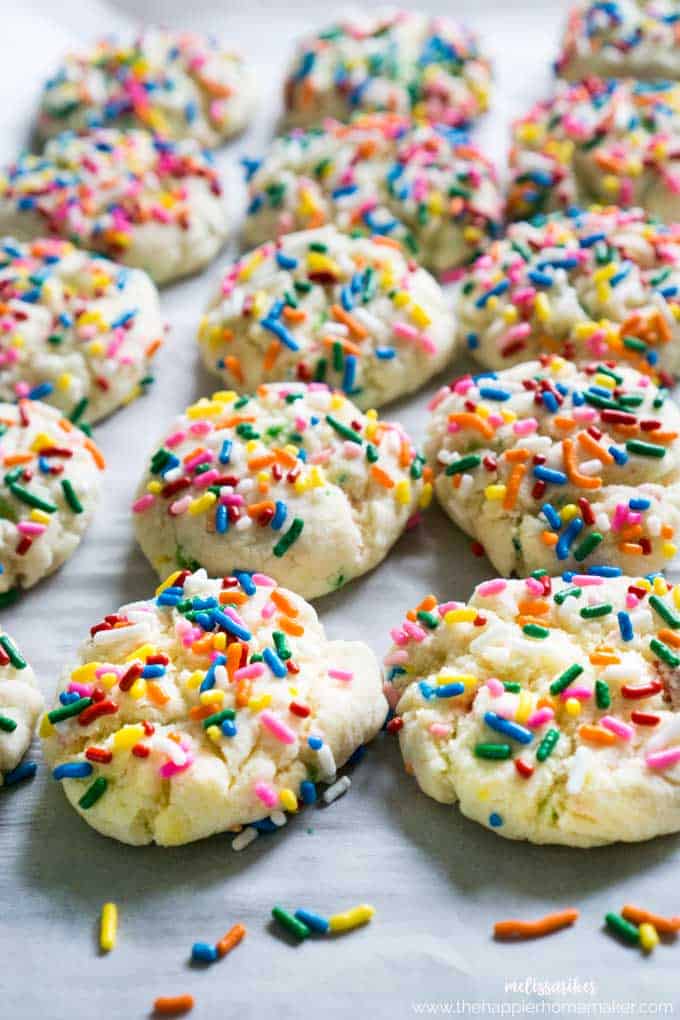 A close up of many funfetti cookies on parchment paper