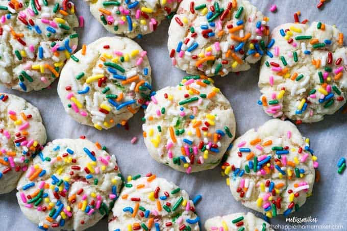 overhead view of cookies with colorful sprinkles on parchment paper