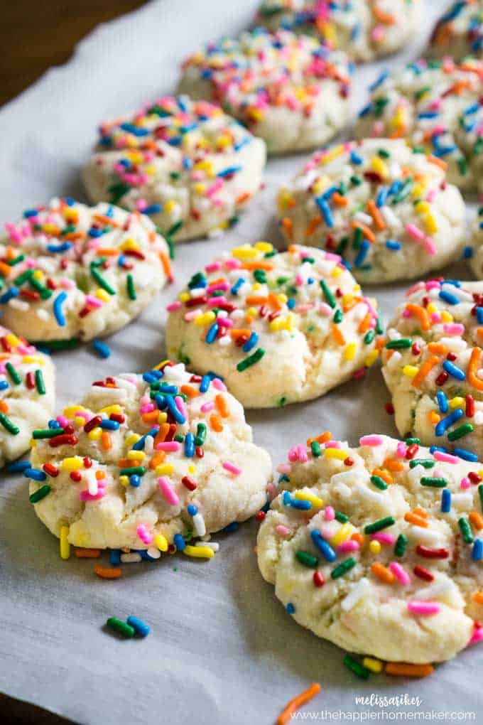 close up of funfetti cookies with colorful sprinkleson parchment paper