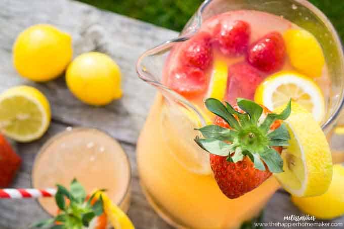 A close up of a pitcher of strawberry lemonade