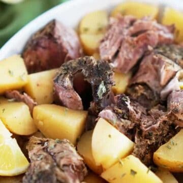 lamb and potatoes in white dish