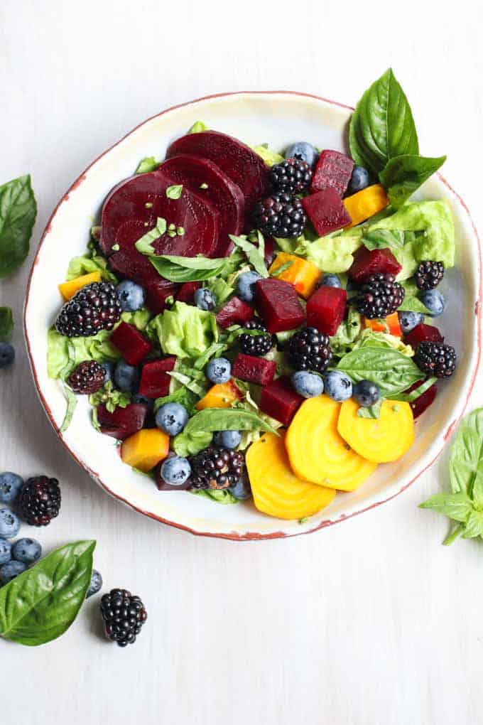 An above picture of beet salad with fresh berries.